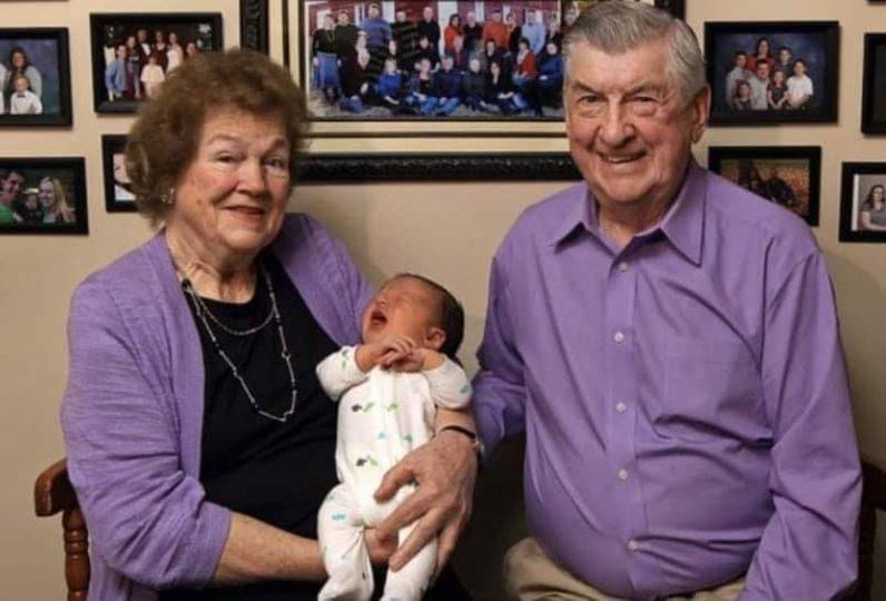 Husband and wife, married for 59 years, greet their 100th grandchild. Four generations together under one roof. Their family photo will astound you.
